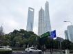 FILE PHOTO: Cars travel past a display showing Shanghai and Shenzhen stock indexes near the Shanghai Tower and other skyscrapers at the Lujiazui financial district in Shanghai, China February 5, 2024. REUTERS/Xihao Jiang/File Photo