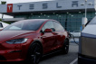 FILE PHOTO: A Tesla model Y is shown charging at a Tesla dealership in Buena Park, California, U.S., January 28, 2026. REUTERS/Mike Blake/File Photo