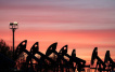 Sunset clouds glow over pump jacks at the Airankol oil field operated by Caspiy Neft in the Atyrau region, Kazakhstan, April 21, 2026. REUTERS/Pavel Mikheyev